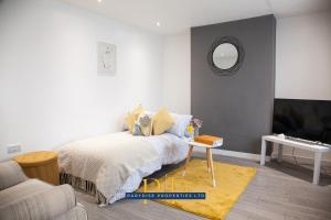 a bedroom with a bed and a table and a mirror at The Knutton House - By Parydise Properties - Perfect for Leisure or Business Stays- Sleeps up to 7 - Stoke on Trent in Newcastle under Lyme