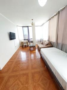 馬查拉的住宿－Departamentos de la Costa，客厅配有床和沙发