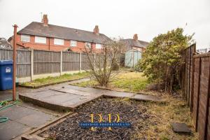 a yard with a fence and a house at The Knutton House - By Parydise Properties - Perfect for Leisure or Business Stays- Sleeps up to 7 - Stoke on Trent in Newcastle under Lyme