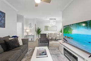 a living room with a large flat screen tv at Royale Blue in Kissimmee