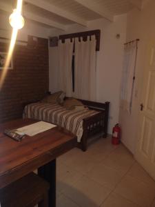 a small bedroom with a bed and a desk at San Juan Apart in Santa Lucía