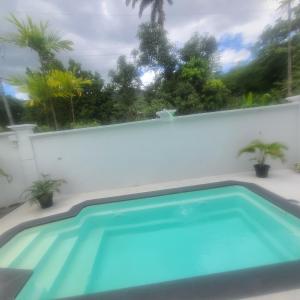 a swimming pool on the side of a house at Riverside Apartments Bed and Breakfast in San Juan