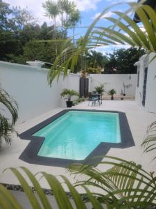 a swimming pool in the middle of a yard at Riverside Bed and Breakfast in San Juan