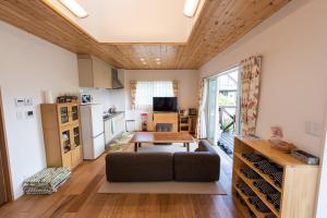 a living room with a couch and a table at Kawaguchiko Superba Vista Annex in Fujikawaguchiko