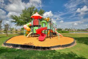 a playground with a slide in a park at Allure - Sleeps 8 - 3 BDM - Disney in Kissimmee