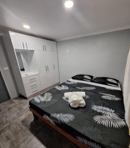 a bedroom with a bed with a stuffed animal on it at Mount Olivet House in Suva