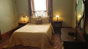 a bedroom with a large bed with a window at The Eleanor Davis House & Pool in Hannibal