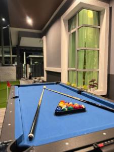 a pool table in a house with at Resthouse Asyura in Melaka