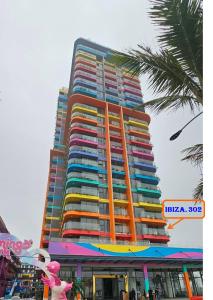 a tall building with colorful balconies on it at Flamingo Ibiza Hải Tiến in Nam Khê