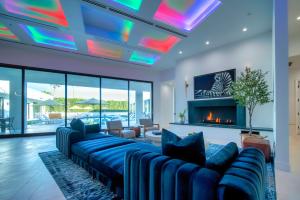 a living room with a blue couch and a fireplace at Old Town Scottsdale Luxury Villa - Heated Pool, Spa, Rooftop Deck, Sauna, Speakeasy in Scottsdale