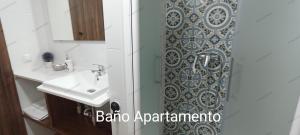 a bathroom with a sink and a shower at El DETALLE Apartamento y Estudio in Zahara de la Sierra