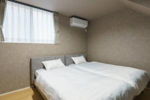 Postel nebo postele na pokoji v ubytování 空翠 - Kusui 1日1組限定の貸切宿