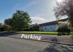 a driveway with a parking sign in front of a house at Chambre au calme proche de la nature in Auxi-le-Château +7 photos