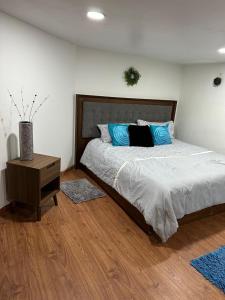 a bedroom with a large bed with blue pillows at Mi Delicioso Escape in San Luis Río Colorado