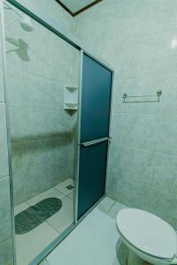 a bathroom with a shower and a toilet at Pousada São Benedito in Santo Antônio do Pinhal