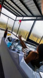 a woman sitting in a jacuzzi in a hot tub at SUITE STARS in Latacunga