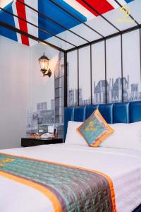 a bedroom with a large bed with a large window at Silk Hotel near Tan Son Nhat Airport in Ho Chi Minh City