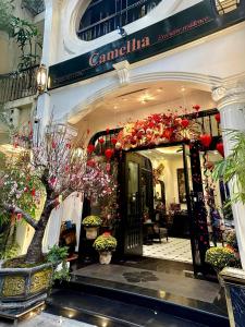 an entrance to a store with flowers and plants at Camellia Residence Hanoi in Hanoi