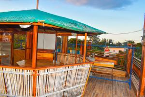 a wooden deck with benches on a boat at Casa de Madera The Wooden House in Cabuyao