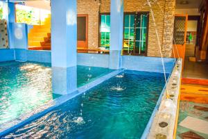 a pool in a house with a swimming pool at Casa de Madera The Wooden House in Cabuyao