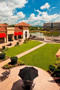 a patio with an umbrella in the middle of a park at The Westin Huntsville in Huntsville