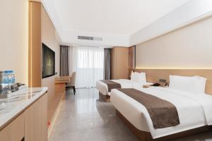 Postel nebo postele na pokoji v ubytování JD POLMAN Hotel