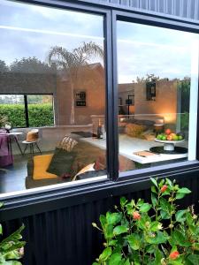 a window with a view of a living room at Tree View Studio in Tauranga