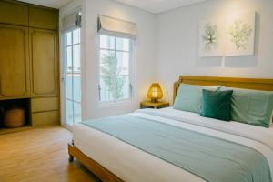 a bedroom with a large bed and a window at Casa Amarta Canggu - Boutique Lofts & Detox SPA in Canggu +139 photos