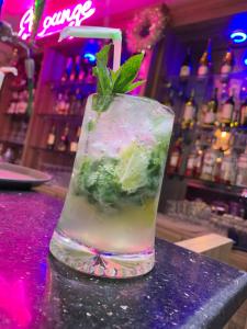 a drink sitting on a counter in a bar at EL Apartment in East Legon