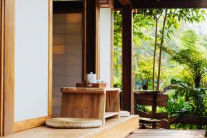 een badkamer op een veranda met een raam bij Harmony Botanical in Buon Ma Thuot