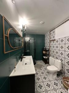 a bathroom with a sink and a toilet at Rakši in Cēsis