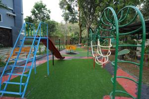 een speeltuin met een glijbaan in een park bij M!steria Inn near Banasura sagar in Wayanad