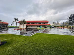 a building with a lot of water in front of it at Americas Best Value Inn Calimesa in Calimesa