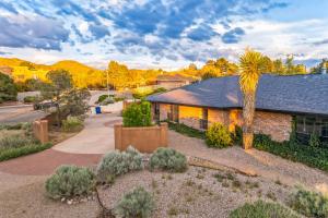 a home with a palm tree and a building at Central BBQ Haven - 4bd - Games - Outdoor Movie in Albuquerque