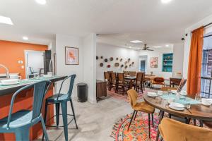 a kitchen and dining room with tables and chairs at Central BBQ Haven - 4bd - Games - Outdoor Movie in Albuquerque