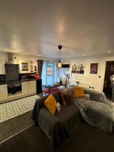 a living room with a large bed and a kitchen at Shropshire Guesthouse in Wolverhampton