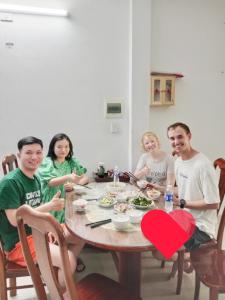 a group of people sitting around a table with a heart on it at BB homestay in Thôn Tiên Nộn