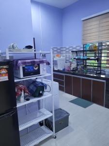 a room with a computer on a shelf at Homestay Haji Noor in Tanah Merah
