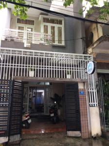 a house with a balcony and a motorcycle in front of it at BB homestay in Thôn Tiên Nộn