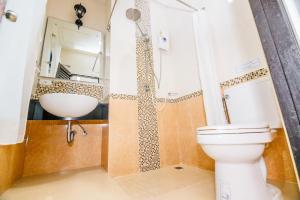a bathroom with a toilet and a sink at The one boutique hotel in Satun +27 photos