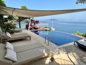 a swimming pool with a view of the ocean at Ece Hotel Sovalye Island in Fethiye