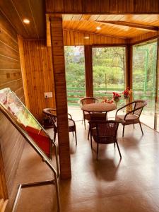 a dining room with a table and chairs at Vista Resort, Manali - centrally Heated & Air cooled luxury rooms in Manāli