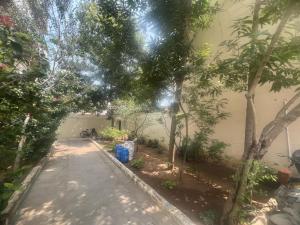an alley way with trees and a building at S V Homes in Kumbakonam +3 photos