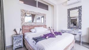 a bedroom with a large mirror and a bed at Waenis Sunset View Hotel and Restaurant, Amed, Bali in Amed +80 photos