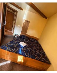 a bedroom with a bed with a blue comforter at Sklep u Dušana in Vracov