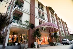 a building with an umbrella in front of it at Boonsiri Boutique Hotel in Si Sa Ket