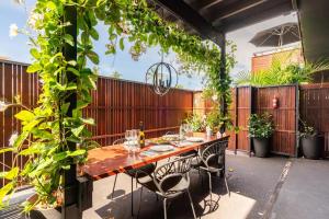 a patio with a wooden table and chairs at 549 Apartments in Hervey Bay