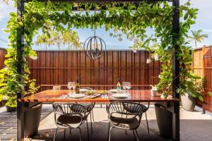 a wooden table and chairs on a patio at 549 Apartments in Hervey Bay