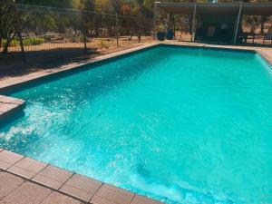a large pool with blue water in a yard at Happy Wanderer Holiday Resort The Grampians in Wartook