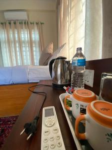 a table with a remote control and a coffee maker on it at Hotel Safari Suite in Sauraha